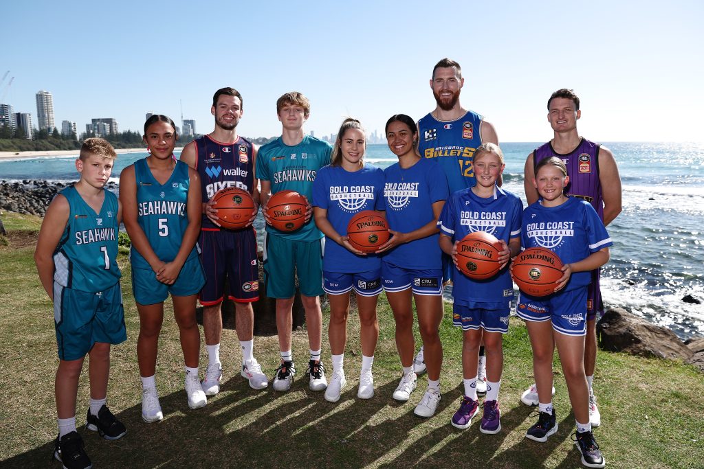 GOLD COAST, AUSTRALIA - JULY 21: Jason Cadee of the Adelaide 36ers, Aron Baynes of the Bullets and Shaun Bruce of the Sydney Kings pose with junior players from North Gold Coast Seahawks and Gold Coast Rollers at the NBL Blitz 2023 Official Launch at Burleigh Heads  on July 21, 2023 in Gold Coast, Australia. (Photo by Chris Hyde/Getty Images)